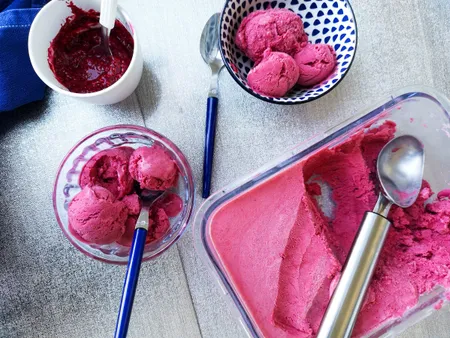 Raspberry ice cream in a small bowl